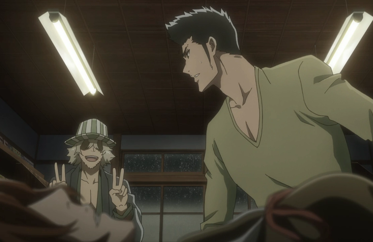 a screenshot from the Bleach anime. it features Isshin in casual clothes behind a prone, safe Masaki. he is looking over his shoulder at Urahara, who is smiling and doing double peace signs